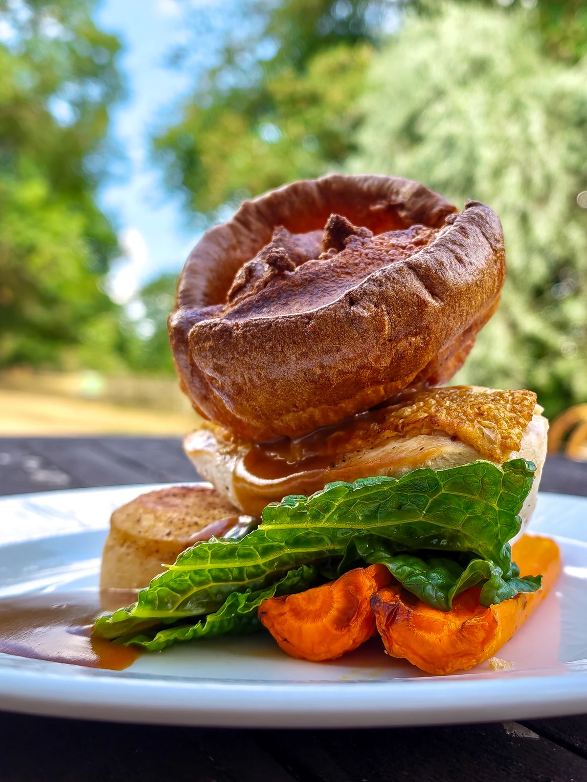 A plated main course on a table in the estate grounds