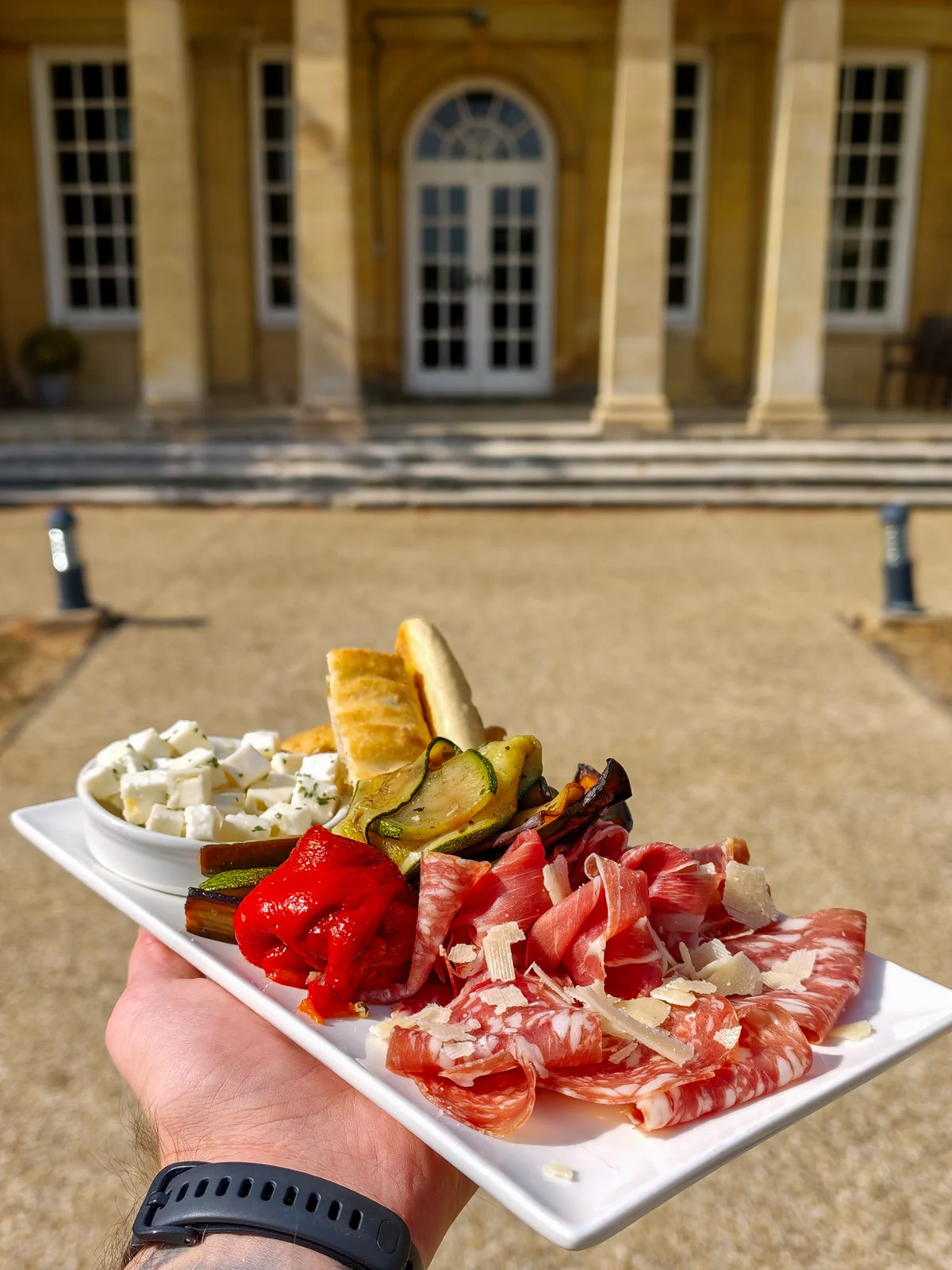 A sharing board of cured meats, cheese and grilled vegetables