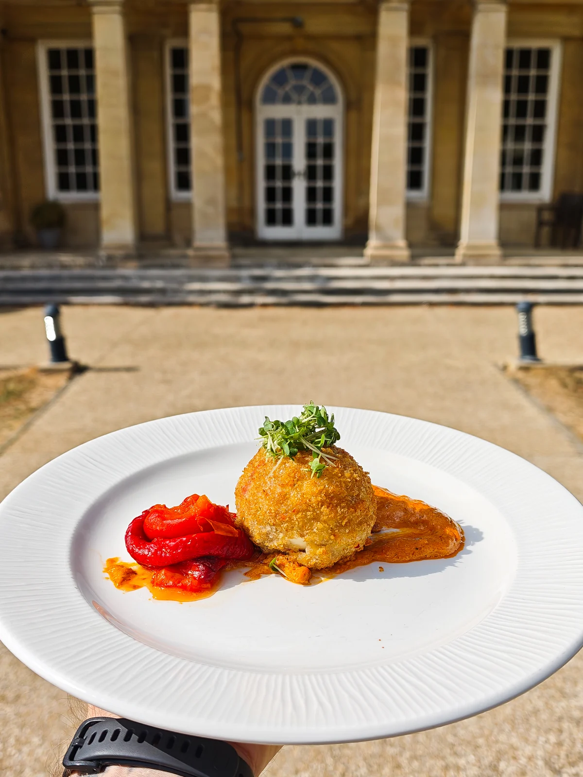 A crumbed croquette with roasted red pepper